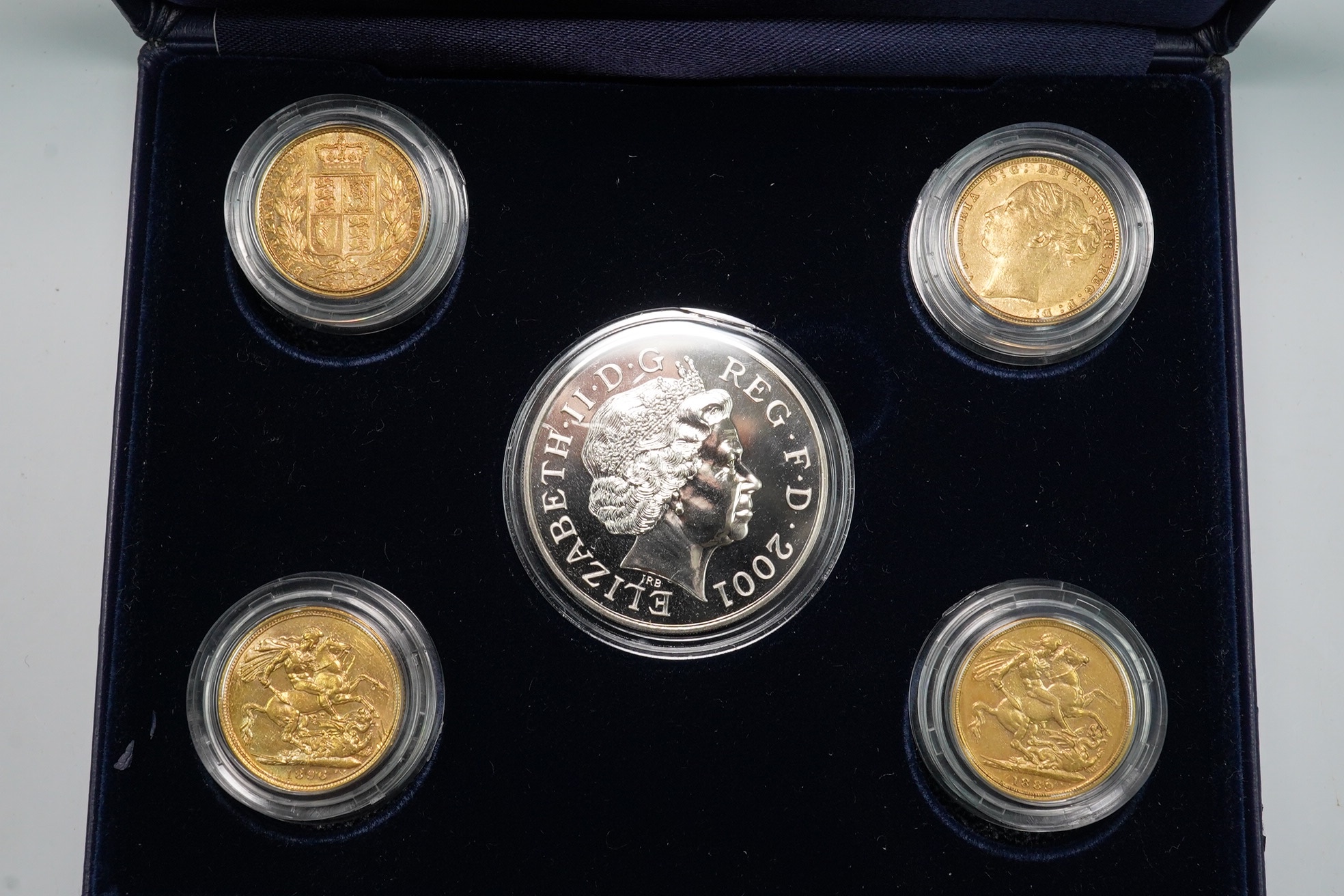 British gold coins, four Victoria gold sovereigns, later cased by Westminster commemorating the centenary of Queen Victoria‘s death, comprising 1876, Fine or better, 1878 VG or better, 1889, about Fine, 1896, obv. scratc